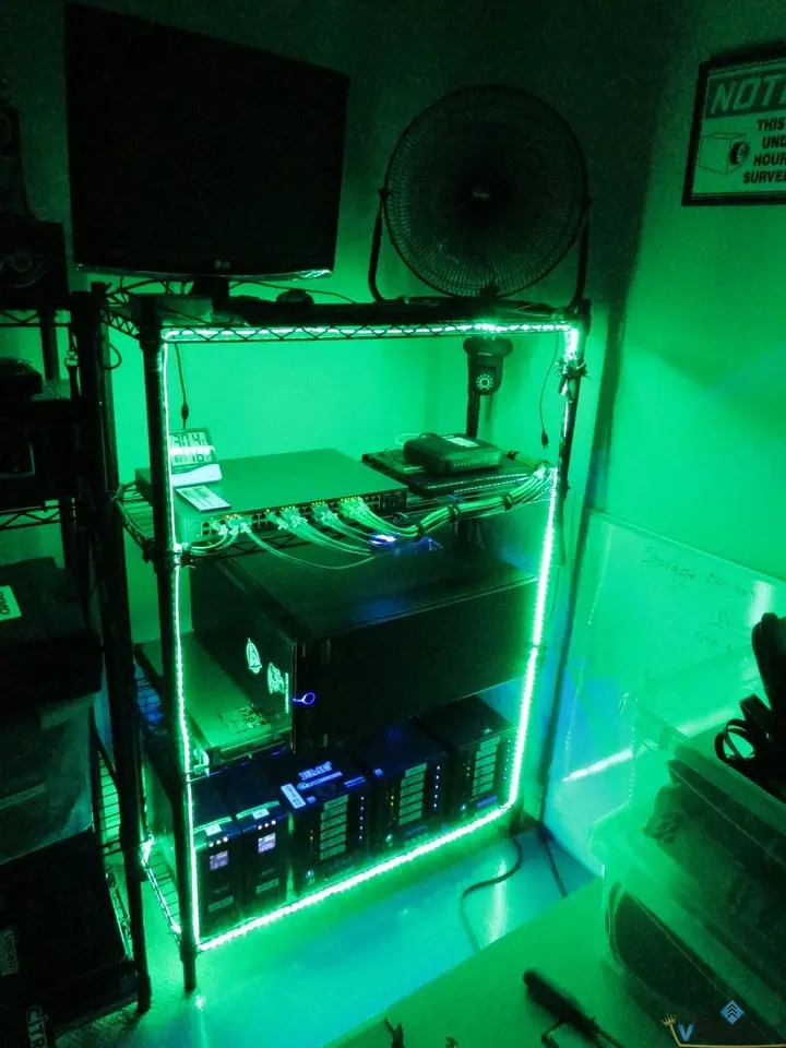 Home lab rack outlined by green LED strips