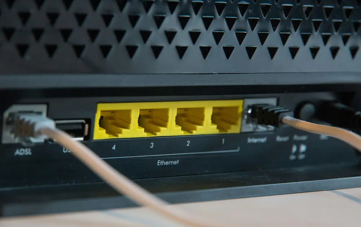 Ethernet cable connected to a router beside empty LAN ports